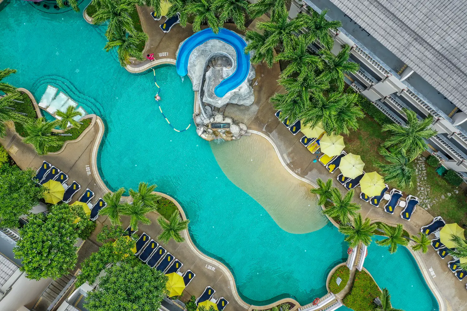 Poolside loungers under yellow parasols