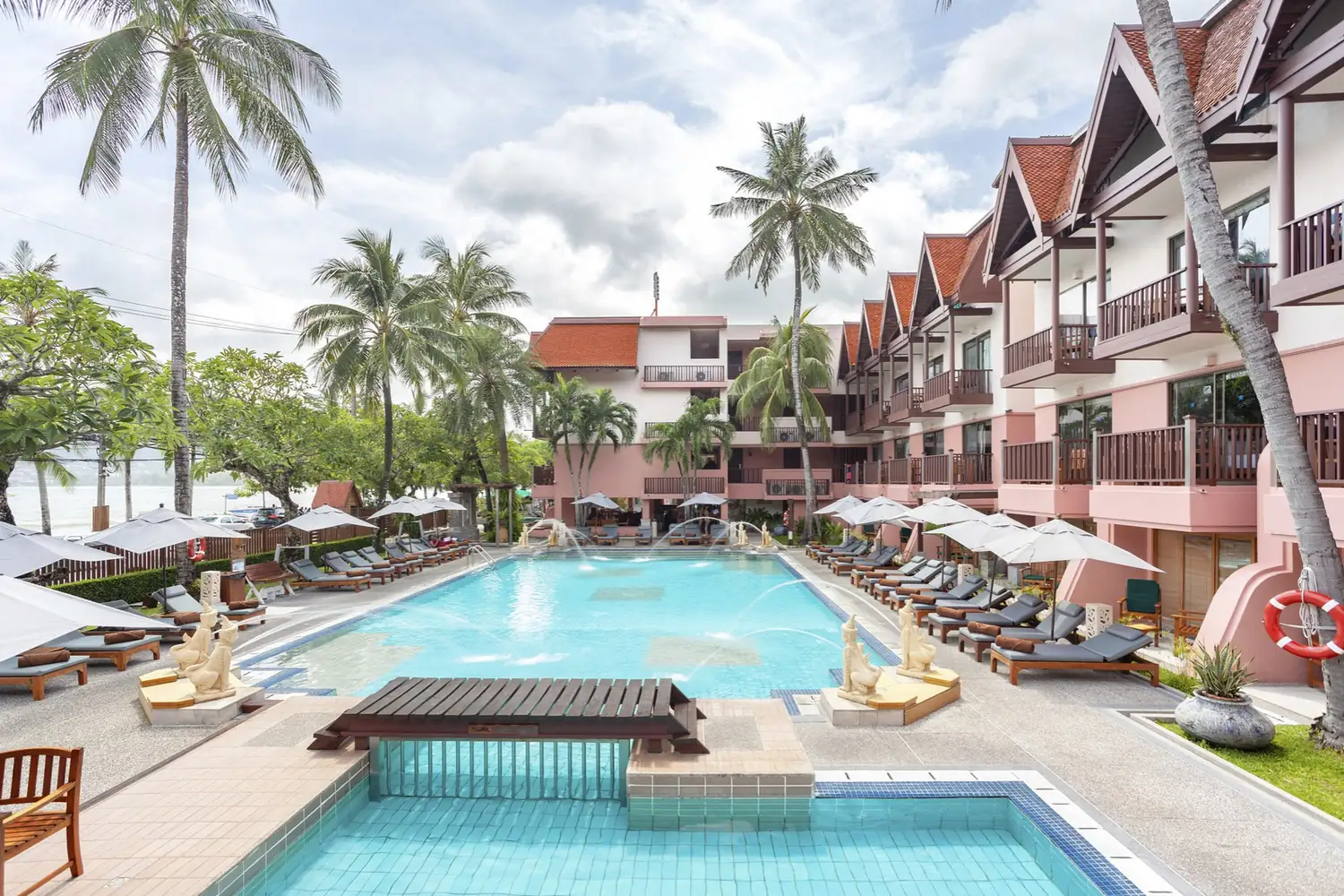 Poolside loungers beneath the palms